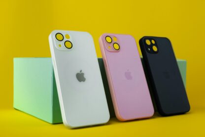 Three colorful smartphone cases displayed on a vibrant yellow background with green box for modern design.